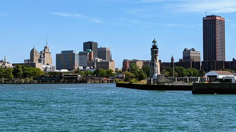 Buffalo skyline and a lighthouse across the harbor