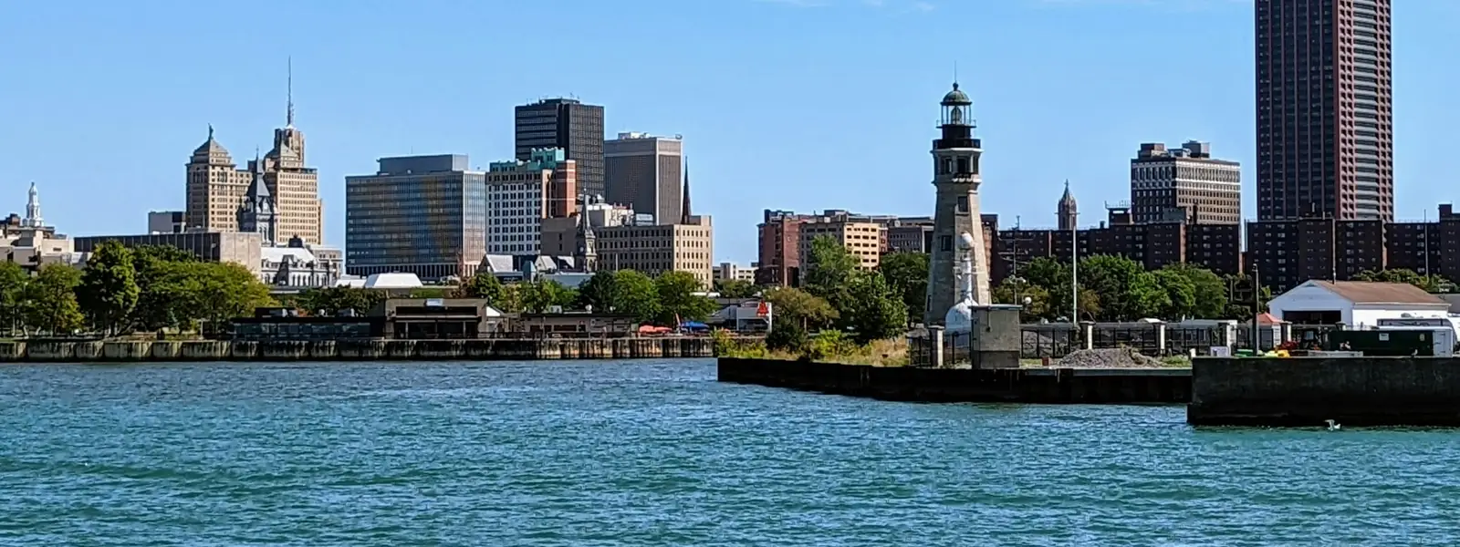 Buffalo skyline and a lighthouse across the harbor