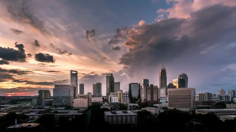 Uptown Charlotte skyline under a stormy sunset sky
