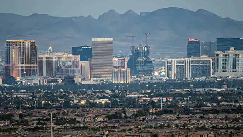Las Vegas skyline with mountains behind it at dusk
