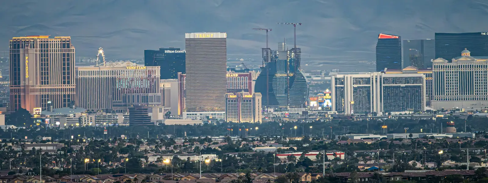 Las Vegas skyline with mountains behind it at dusk