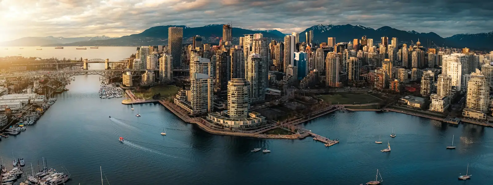 Aerial view of downtown Vancouver and False Creek with the mountains